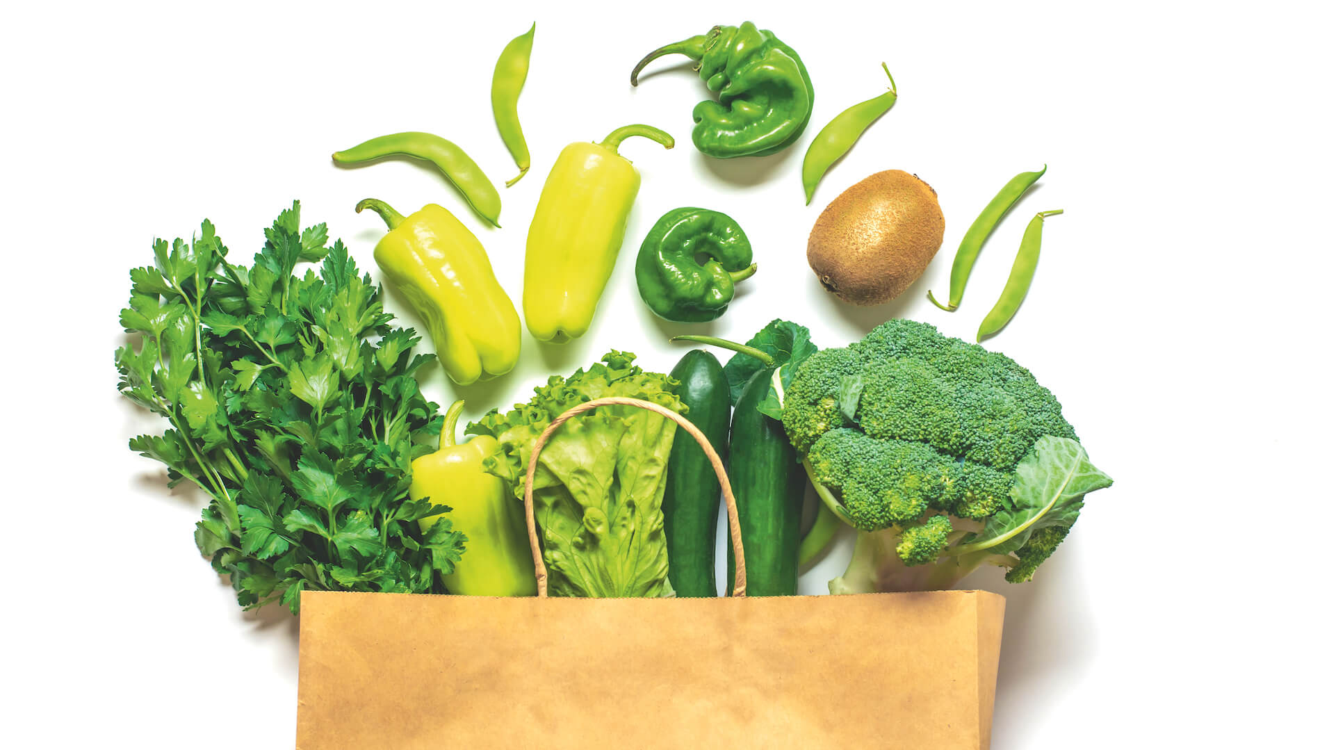 Does the gluten-free diet give you constipation? Dietitian for Coeliac Australia, Penny Dellsperger, shares her advice. Image for green fruits and vegetables spilling out of a brown paper bag.