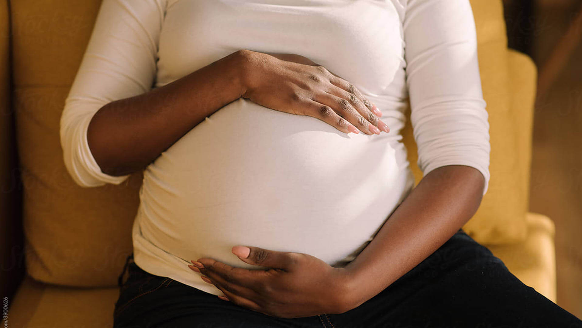 Coeliac disease and infertility: a women gently holding her roundee, pregnant belly